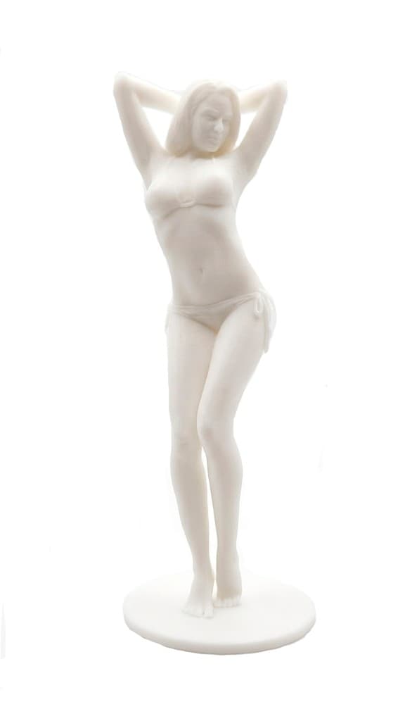 Single-color resin figurine of a woman with arms raised